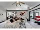 Open-concept living room showcasing a vaulted ceiling, stylish decor, modern fan, and seamless flow into other areas at 2190 Ashley Crossing Ct, Lawrenceville, GA 30043