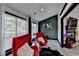 Modern living room featuring bright windows, hardwood floors, and stylish red egg chairs at 2190 Ashley Crossing Ct, Lawrenceville, GA 30043