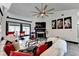 Bright living room featuring a vaulted ceiling, fireplace, and stylish decor with modern ceiling fan at 2190 Ashley Crossing Ct, Lawrenceville, GA 30043