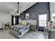 Stylish main bedroom boasts a tray ceiling, accent wall, and modern furnishings at 2190 Ashley Crossing Ct, Lawrenceville, GA 30043