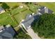 Aerial view showcasing a lush, green backyard and mature trees surrounding the property at 3027 Biltmore Woods Dr, Buford, GA 30519