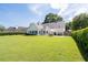 A well-manicured lawn highlights the back of this home with a spacious backyard at 3027 Biltmore Woods Dr, Buford, GA 30519