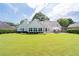 A well-manicured lawn highlights the back of this home with a spacious backyard at 3027 Biltmore Woods Dr, Buford, GA 30519