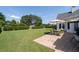 Backyard featuring a stone patio with outdoor dining and a manicured lawn at 3027 Biltmore Woods Dr, Buford, GA 30519