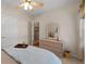 Bedroom with dresser, ceiling fan, and a view into another room at 3027 Biltmore Woods Dr, Buford, GA 30519
