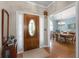Inviting foyer featuring a hardwood door with decorative glass and a glimpse into the adjacent dining room at 3027 Biltmore Woods Dr, Buford, GA 30519