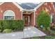 Inviting front entrance with a well-kept lawn and shrubbery surrounding the walkway to the front door at 3027 Biltmore Woods Dr, Buford, GA 30519
