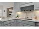 Bright kitchen with white countertops, stainless steel sink, and neutral backsplash at 3027 Biltmore Woods Dr, Buford, GA 30519