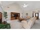 Bright living room showcasing a fireplace, built-in entertainment center, and comfortable seating at 3027 Biltmore Woods Dr, Buford, GA 30519
