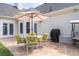 Relaxing outdoor patio with stone floor, seating, and a grill perfect for entertaining guests at 3027 Biltmore Woods Dr, Buford, GA 30519