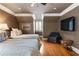 Comfortable bedroom featuring twin beds, hardwood floors, TV, and cozy seating area, ideal for relaxation at 567 N Palisades Se Cir, Marietta, GA 30067