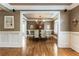 Elegant dining room with chandelier, hardwood floors, wainscoting, and a view of the outdoors at 567 N Palisades Se Cir, Marietta, GA 30067