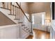 Bright foyer with a hardwood floor, staircase with white railings, and an entry door with sidelights at 567 N Palisades Se Cir, Marietta, GA 30067