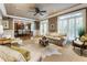 Spacious living room open to dining area, featuring neutral walls, ceiling fan, and ample seating at 567 N Palisades Se Cir, Marietta, GA 30067