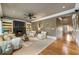 Cozy living room features hardwood floors, a fireplace with built-in shelving, and comfortable seating arrangement at 567 N Palisades Se Cir, Marietta, GA 30067