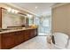 A spa-like main bathroom features a soaking tub, glass shower, and granite-topped vanity at 567 N Palisades Se Cir, Marietta, GA 30067