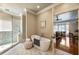 A luxurious bathroom includes a soaking tub, glass shower, and seamless access to the main bedroom at 567 N Palisades Se Cir, Marietta, GA 30067