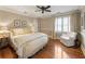 Inviting main bedroom featuring a bed, chair, ceiling fan, and natural light from the window at 567 N Palisades Se Cir, Marietta, GA 30067