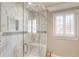 Contemporary glass shower featuring marble walls, a built-in seat, and sleek fixtures at 567 N Palisades Se Cir, Marietta, GA 30067