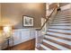 An open staircase features hardwood treads, and white risers, with decorative wainscoting nearby at 567 N Palisades Se Cir, Marietta, GA 30067