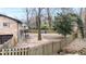 Secluded backyard with a wooden fence, mature trees, and potential for outdoor entertainment at 1343 Renee Dr, Decatur, GA 30035