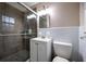 Well-lit bathroom featuring a vanity, sink, a glass shower, and a modern toilet at 1343 Renee Dr, Decatur, GA 30035