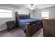 Comfortable bedroom features a wood bed frame, ceiling fan, a dresser, and natural light from two windows at 1343 Renee Dr, Decatur, GA 30035