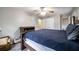 Comfortable bedroom features a wood bed frame, ceiling fan, a dresser, and natural light from two windows at 1343 Renee Dr, Decatur, GA 30035