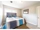Comfortable bedroom features a plush bed, stylish accent chair, and ample natural light from the window at 1343 Renee Dr, Decatur, GA 30035