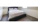 Comfortable bedroom features a gray upholstered bed and base, accented by white wainscoting at 1343 Renee Dr, Decatur, GA 30035
