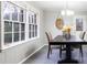 Dining room features large windows, a modern light fixture, and gray plank flooring at 1343 Renee Dr, Decatur, GA 30035