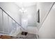 A clean and inviting entryway with white wainscoting, an interesting white bannister, tile flooring, and chandelier at 1343 Renee Dr, Decatur, GA 30035