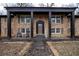 Charming brick home featuring a symmetrical facade, covered porch with columns, and landscaped front yard at 1343 Renee Dr, Decatur, GA 30035