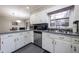 Well-lit kitchen with stainless steel dishwasher and breakfast nook with granite counters at 1343 Renee Dr, Decatur, GA 30035