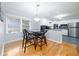 Eat-in kitchen with stainless steel appliances, breakfast bar, and hardwood floors at 1343 Renee Dr, Decatur, GA 30035