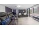 Bright living room offering stylish leather couches, laminate flooring, and a large sliding door leading to the back at 1343 Renee Dr, Decatur, GA 30035
