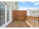 Back deck featuring wood and rail construction and a partial privacy fence at 5529 Festival Ave, Fairburn, GA 30213