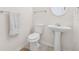 A well-lit half bathroom with a pedestal sink and neutral decor at 5529 Festival Ave, Fairburn, GA 30213