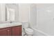 Bathroom featuring a white vanity sink, toilet, and a shower with tub at 5529 Festival Ave, Fairburn, GA 30213