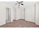 Bedroom featuring neutral walls, two white doors, carpeting, and access to the bathroom at 5529 Festival Ave, Fairburn, GA 30213