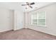 Bedroom featuring a window and ceiling fan, neutral walls and carpeting at 5529 Festival Ave, Fairburn, GA 30213