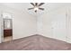 Bright bedroom featuring neutral walls, ceiling fan, and adjacent bathroom entrance at 5529 Festival Ave, Fairburn, GA 30213