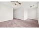 Bedroom featuring a tray ceiling, ceiling fan, and two white doors at 5529 Festival Ave, Fairburn, GA 30213