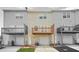 Exterior view of townhomes with individual garages, decks, and beige siding at 5529 Festival Ave, Fairburn, GA 30213