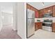 Galley kitchen featuring stainless steel appliances and wooden cabinetry at 5529 Festival Ave, Fairburn, GA 30213