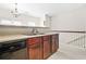 Open kitchen design with dark cabinets, stainless steel sink, and black dishwasher at 5529 Festival Ave, Fairburn, GA 30213