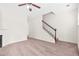 Spacious living room with a cozy fireplace, ceiling fan, and staircase at 5529 Festival Ave, Fairburn, GA 30213