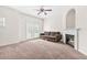 Inviting living room featuring a cozy fireplace, ceiling fan, and sliding doors to the outdoor space at 5529 Festival Ave, Fairburn, GA 30213