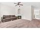 Inviting living room featuring a cozy fireplace, ceiling fan, and ample space for relaxing and entertaining at 5529 Festival Ave, Fairburn, GA 30213