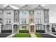 Charming multi-story townhouse with stone and siding exterior, complemented by well-manicured landscaping at 5529 Festival Ave, Fairburn, GA 30213
